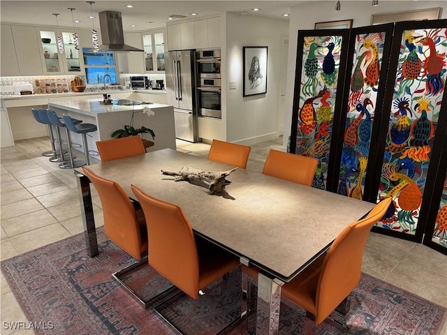 dining room with light tile patterned floors and sink