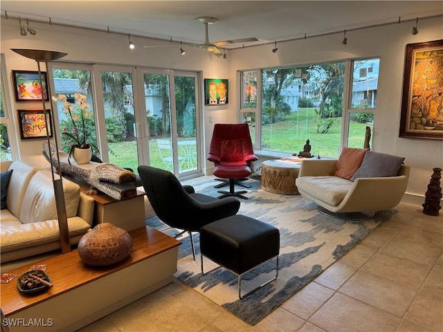 sitting room featuring light tile patterned flooring and track lighting