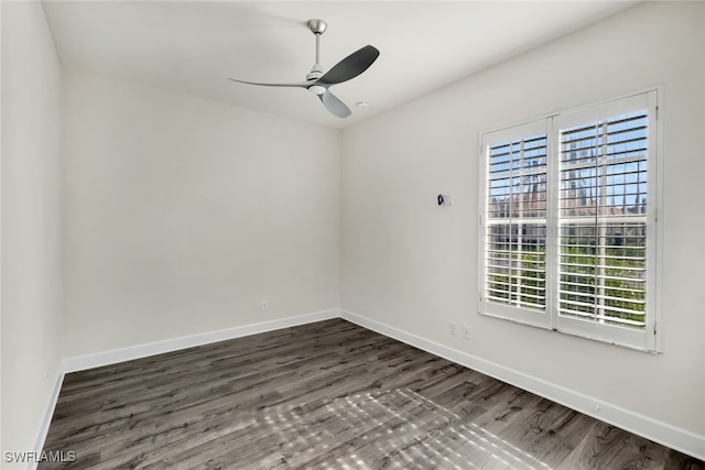 spare room with dark hardwood / wood-style flooring and ceiling fan