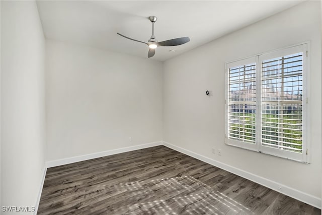 empty room featuring ceiling fan and dark wood-type flooring