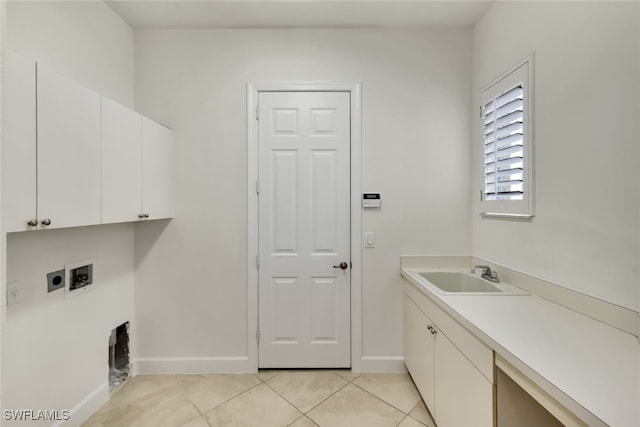 laundry room with electric dryer hookup, cabinets, sink, hookup for a washing machine, and light tile patterned flooring