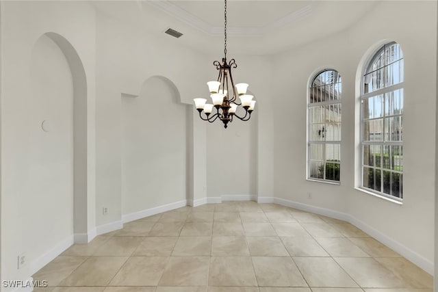 unfurnished dining area with a notable chandelier, light tile patterned floors, crown molding, and a tray ceiling