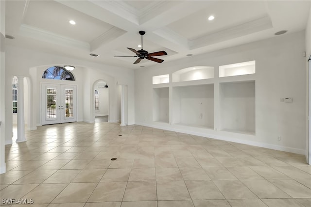 empty room with french doors, coffered ceiling, ceiling fan, beamed ceiling, and light tile patterned flooring