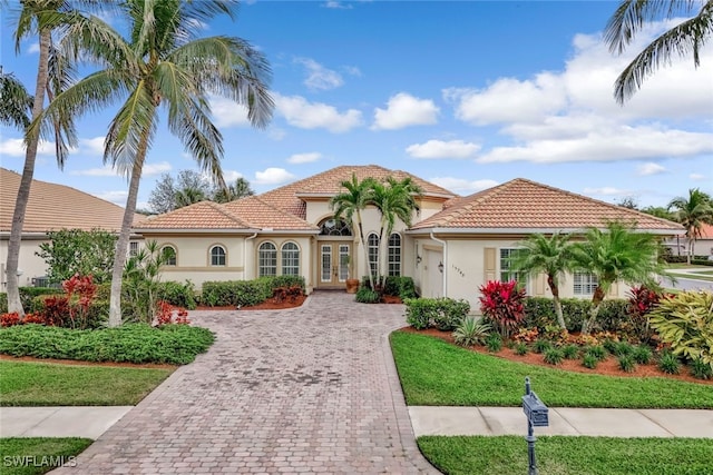 mediterranean / spanish house with a front yard