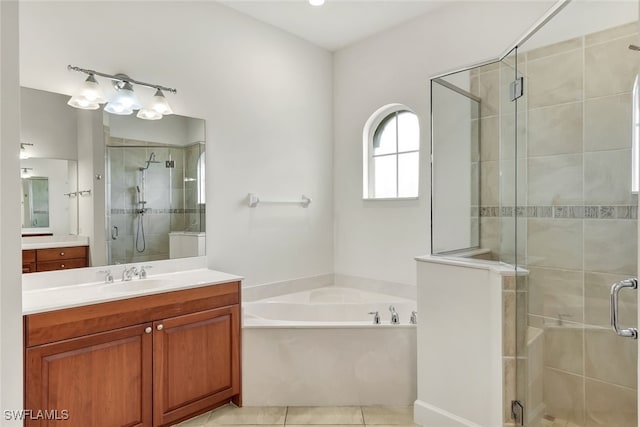 bathroom featuring tile patterned floors, vanity, and independent shower and bath