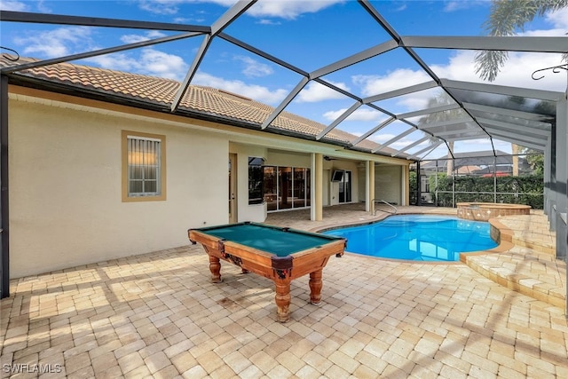 view of swimming pool featuring a lanai, an in ground hot tub, and a patio