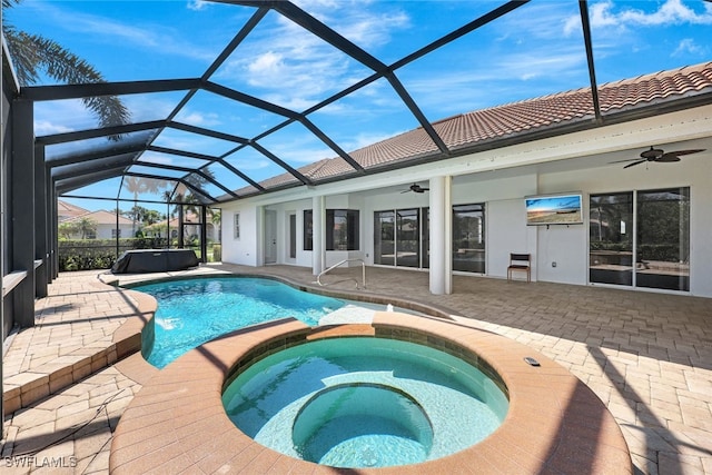 pool featuring ceiling fan, glass enclosure, a patio, and an outdoor hot tub