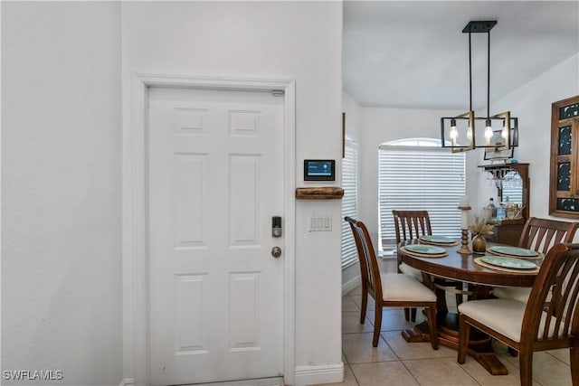 tiled dining space with a notable chandelier