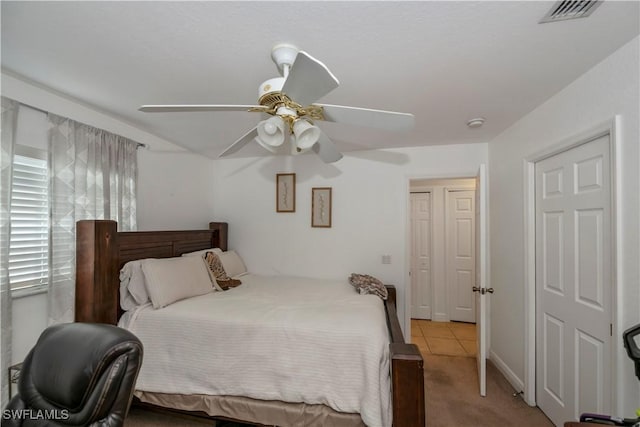 bedroom with light tile patterned floors and ceiling fan