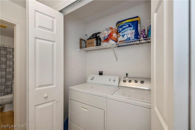 laundry room featuring washing machine and clothes dryer