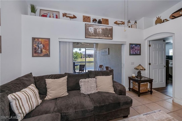 tiled living room with ceiling fan