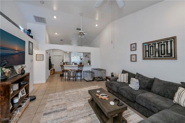 living room featuring light tile patterned floors, high vaulted ceiling, and ceiling fan