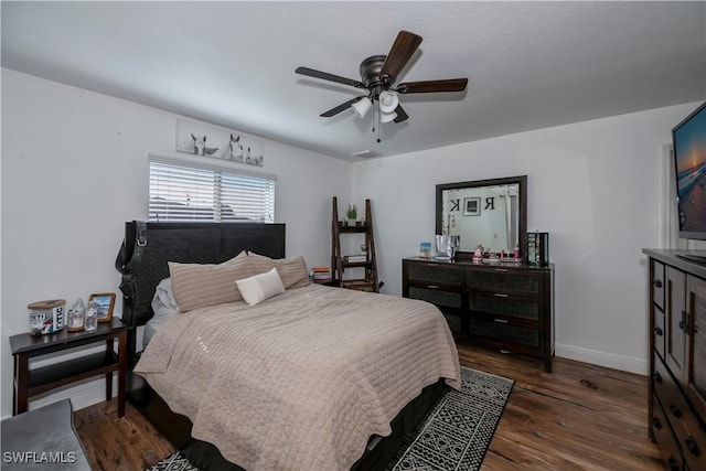 bedroom with ceiling fan and dark wood-type flooring