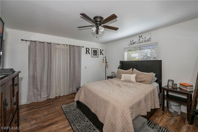 bedroom featuring ceiling fan and dark hardwood / wood-style flooring