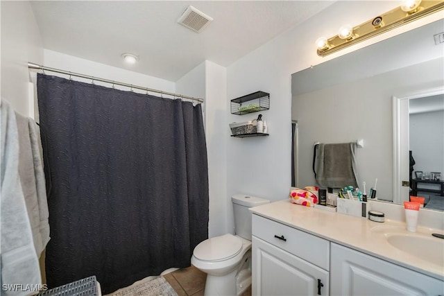 bathroom featuring tile patterned floors, vanity, and toilet