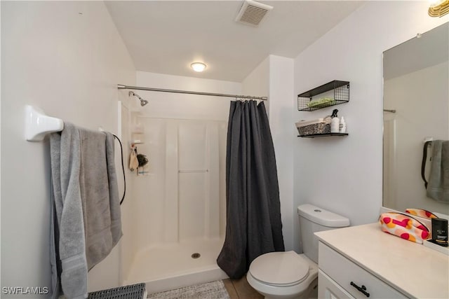 bathroom with toilet, vanity, and a shower with shower curtain