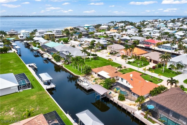 birds eye view of property with a water view