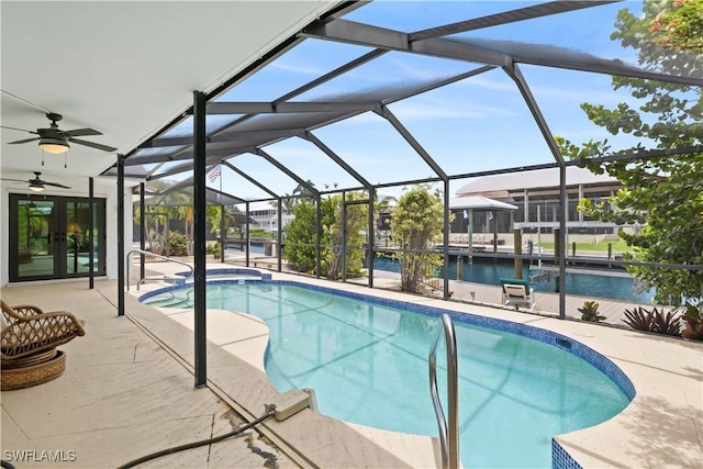 view of pool featuring ceiling fan, french doors, a lanai, a water view, and a patio