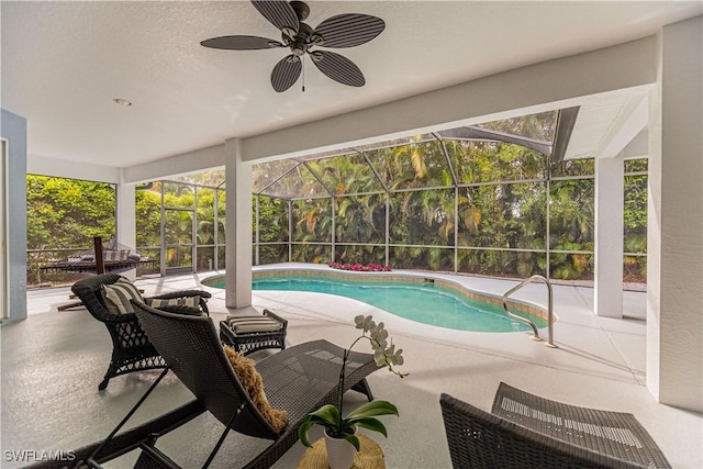 view of swimming pool featuring a patio, ceiling fan, and a lanai