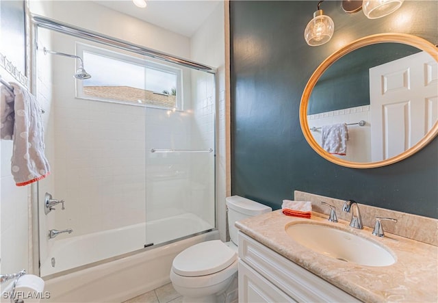 full bathroom with shower / bath combination with glass door, tile patterned floors, vanity, and toilet