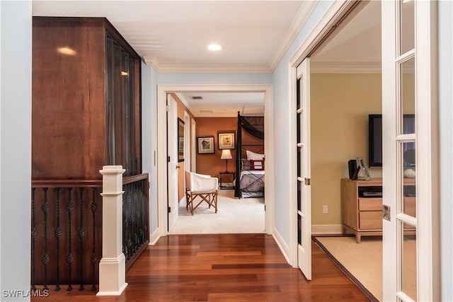 hall featuring hardwood / wood-style flooring, ornamental molding, and french doors