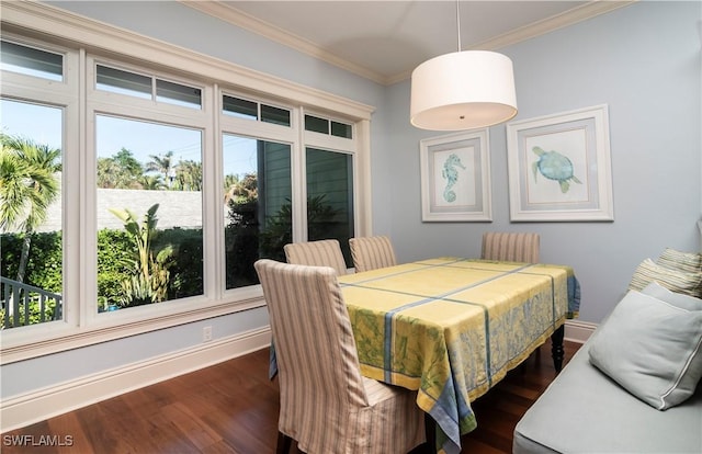 dining space with dark wood-type flooring and ornamental molding