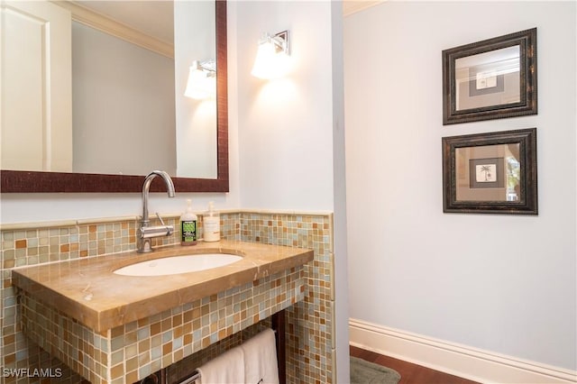 bathroom featuring crown molding, vanity, and hardwood / wood-style floors