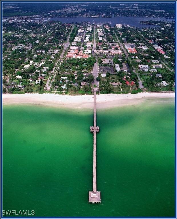 birds eye view of property with a beach view and a water view