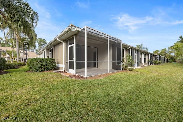 back of property featuring a lawn and a patio