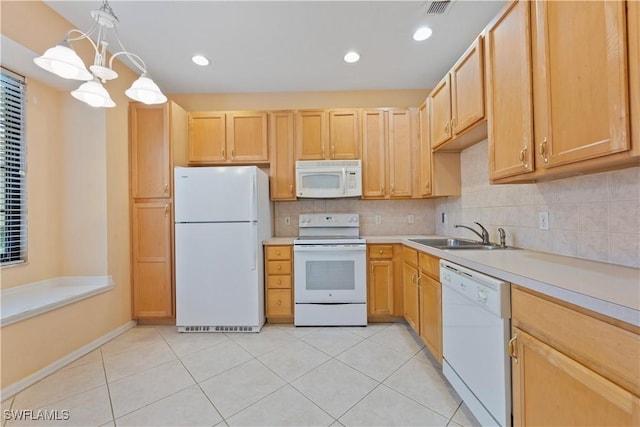 kitchen with white appliances, light brown cabinets, sink, hanging light fixtures, and light tile patterned flooring