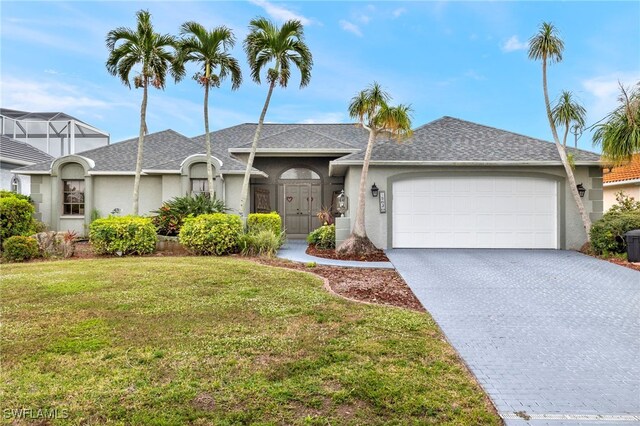 ranch-style house with a garage and a front lawn