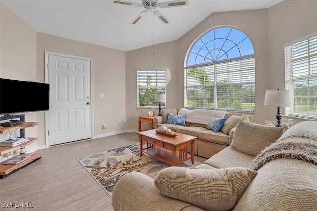 living room with ceiling fan, light wood-type flooring, and lofted ceiling