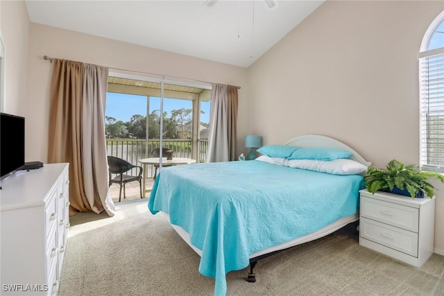 carpeted bedroom featuring ceiling fan, lofted ceiling, and access to outside