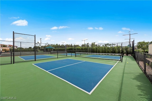 view of tennis court featuring basketball hoop