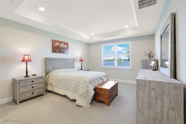 carpeted bedroom featuring a tray ceiling and crown molding