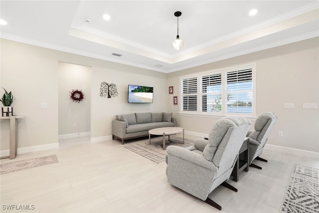 living room featuring a raised ceiling and crown molding