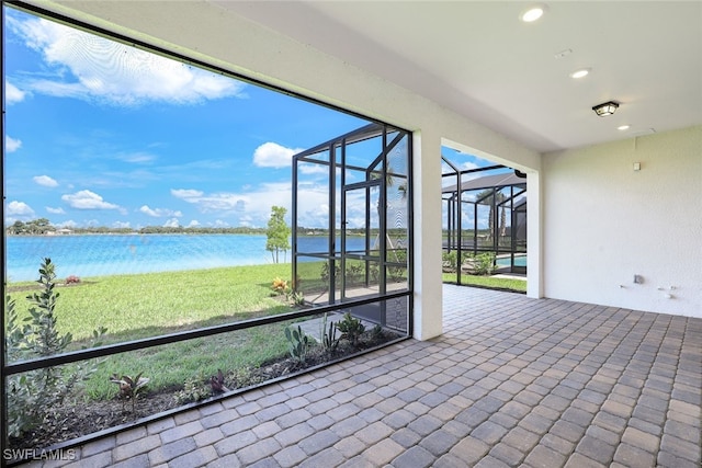 unfurnished sunroom featuring a water view