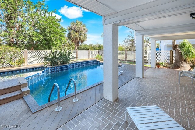 view of swimming pool with a patio and pool water feature