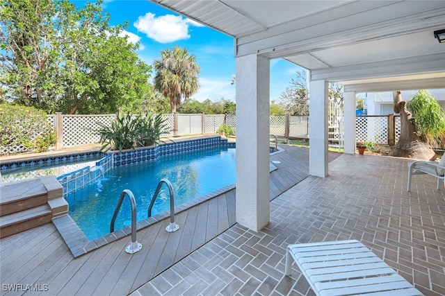 view of swimming pool featuring a fenced backyard and a pool with connected hot tub