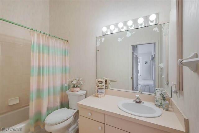 full bathroom with vanity, shower / tub combo with curtain, and toilet