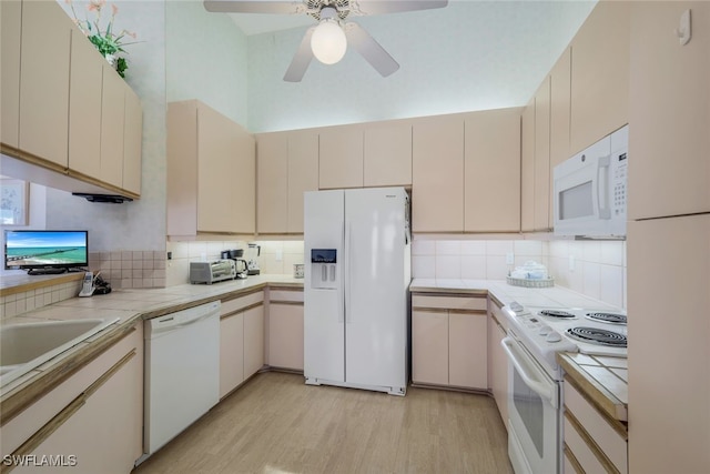 kitchen featuring white appliances and cream cabinetry