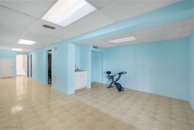 workout area with a paneled ceiling