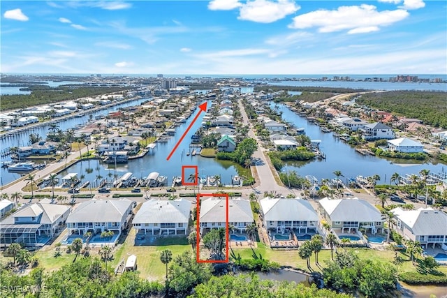 birds eye view of property with a residential view and a water view