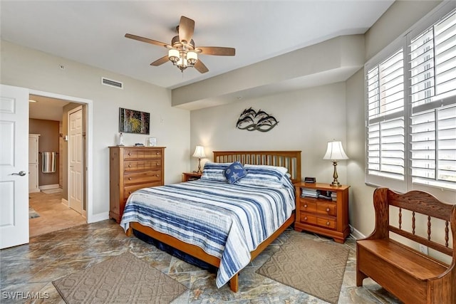 bedroom with ceiling fan and ensuite bath