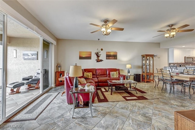 living room featuring ceiling fan and plenty of natural light