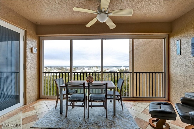 sunroom featuring ceiling fan