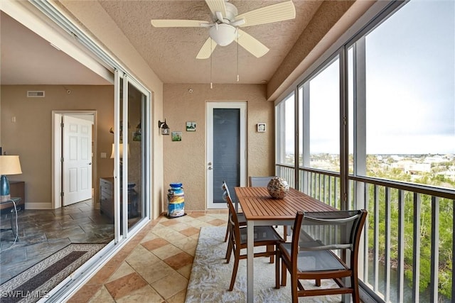 sunroom / solarium featuring ceiling fan