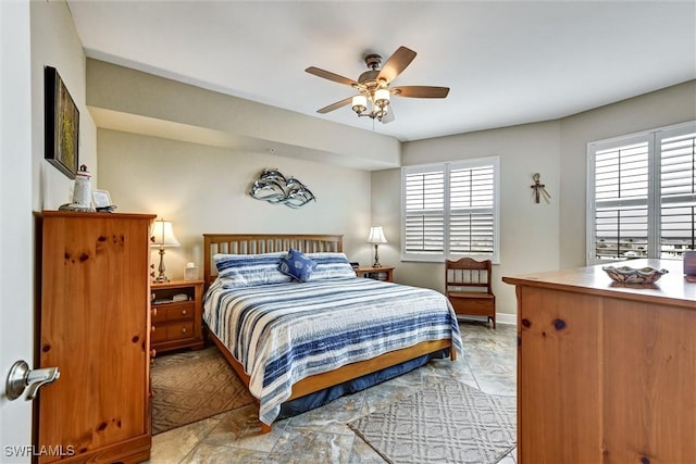 bedroom with ceiling fan and multiple windows