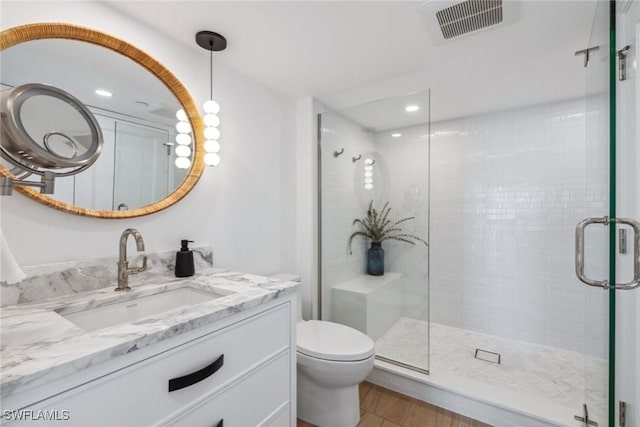 bathroom featuring a shower with door, wood-type flooring, toilet, and vanity