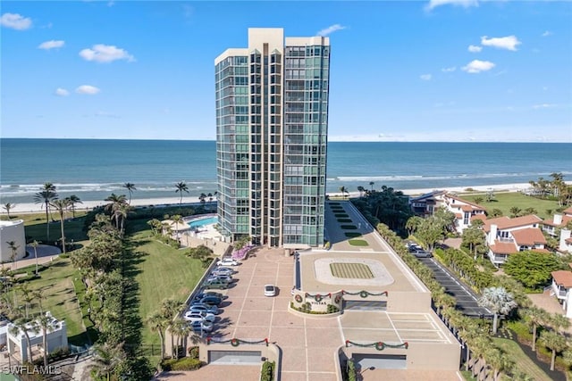 drone / aerial view featuring a water view and a view of the beach